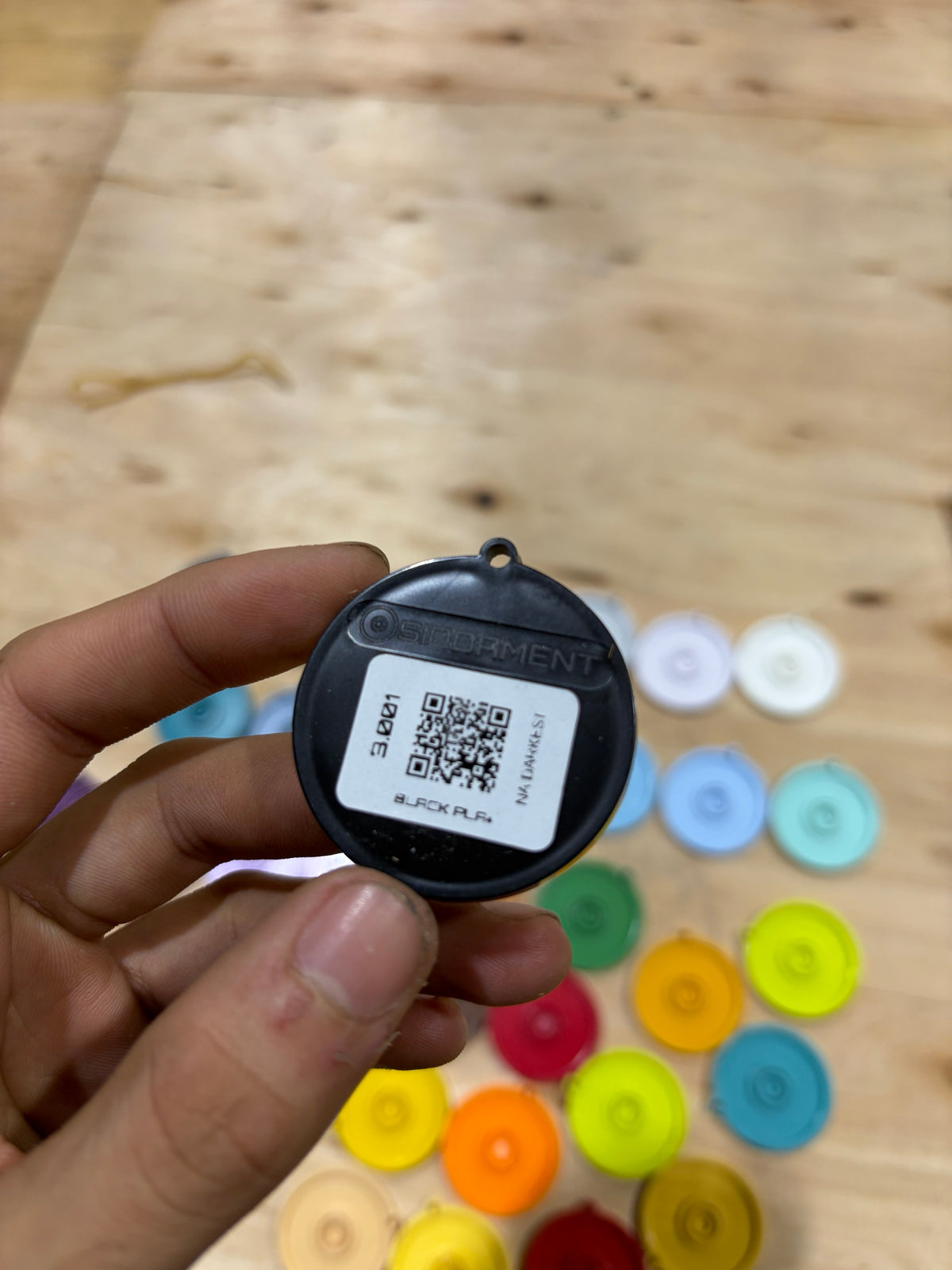 Back of a swatch disc showing the SKU, colour name and QR code
